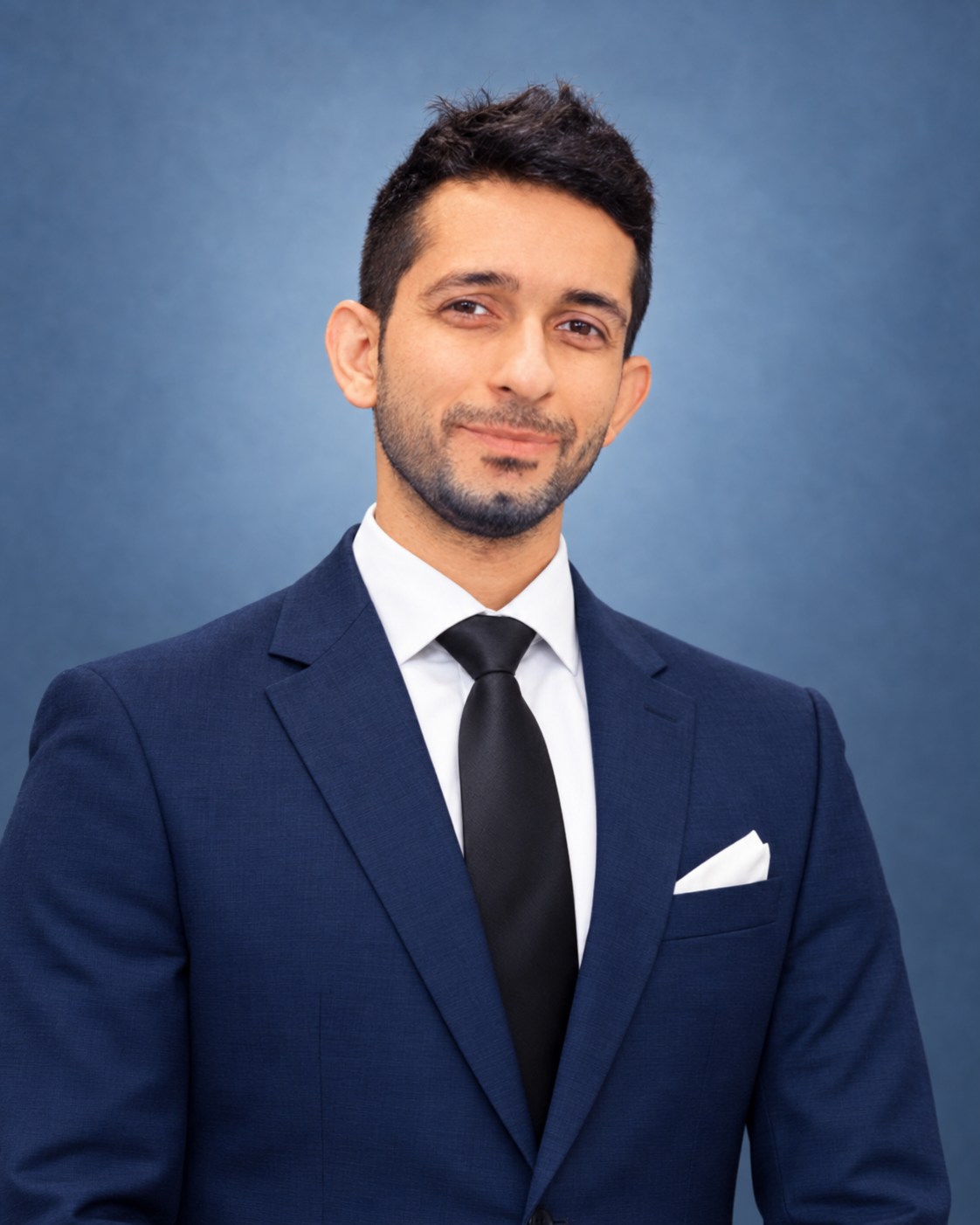 Kushal Kapoor, founder of MAY I HOSPITALITY, in a navy suit.